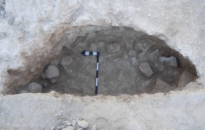 Figure 4. A partially excavated pit at WQ117 with mud bricks arranged at the bottom.